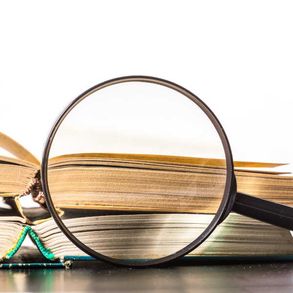 books and magnifying glass